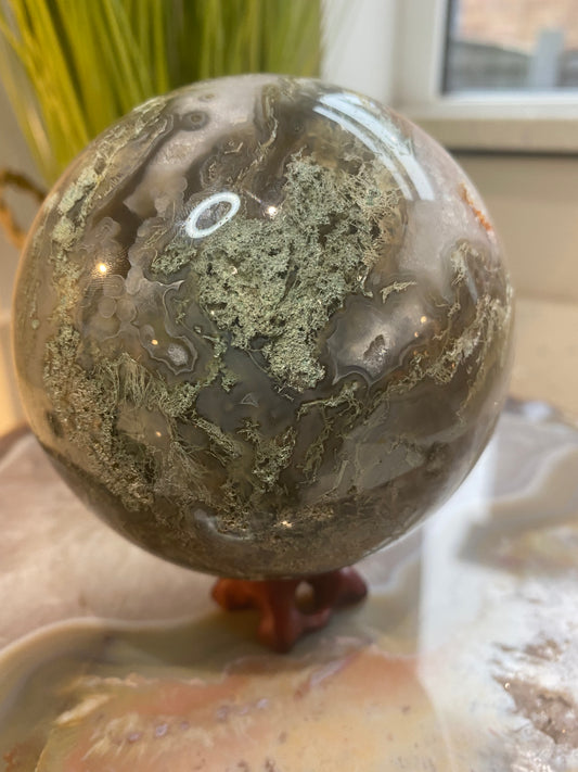Moss agate sphere with Druze